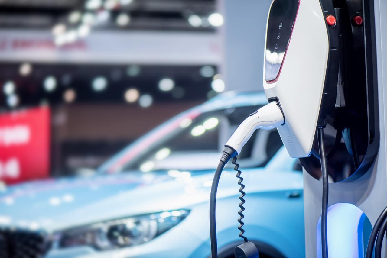 Voiture hybride en pleinde recharge sur une borne.