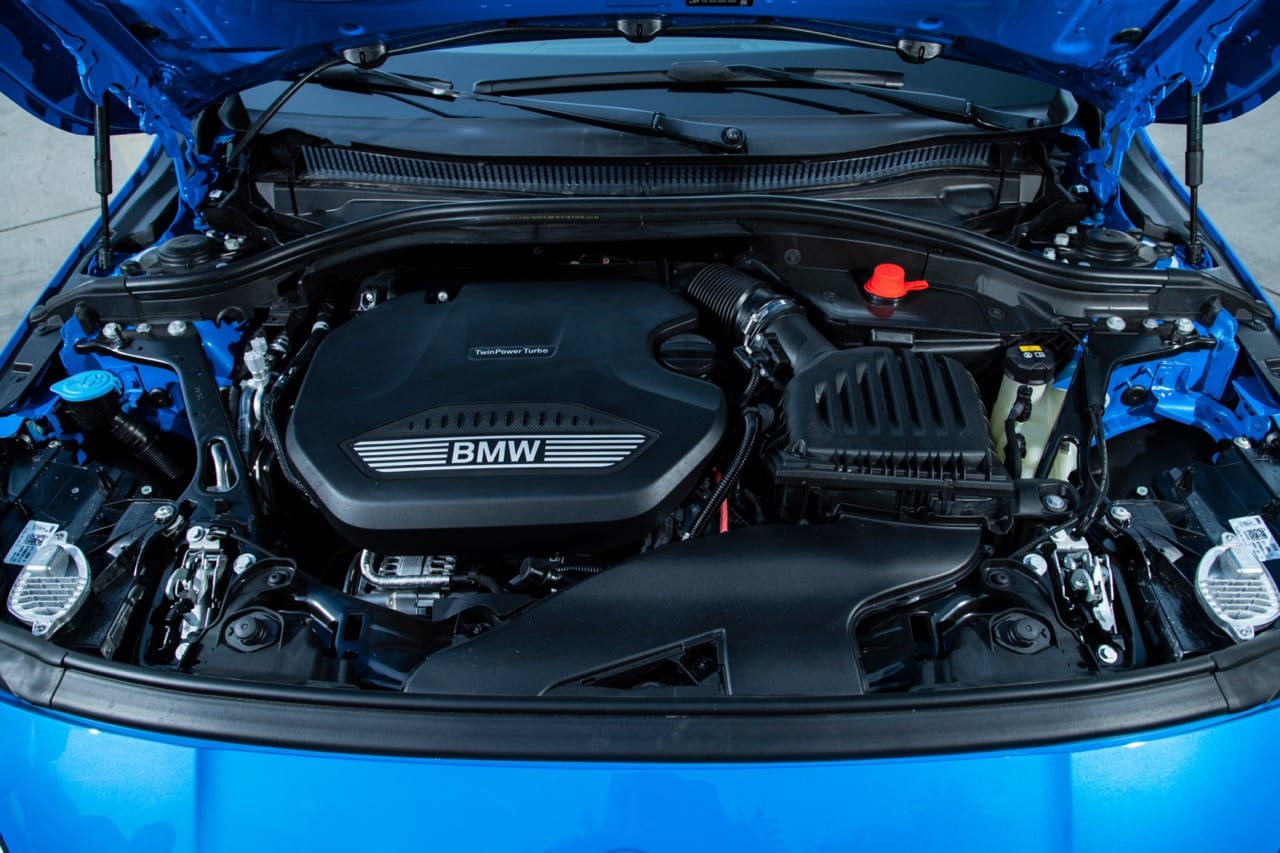 Photo de la batterie d'une BMW sous le capot.